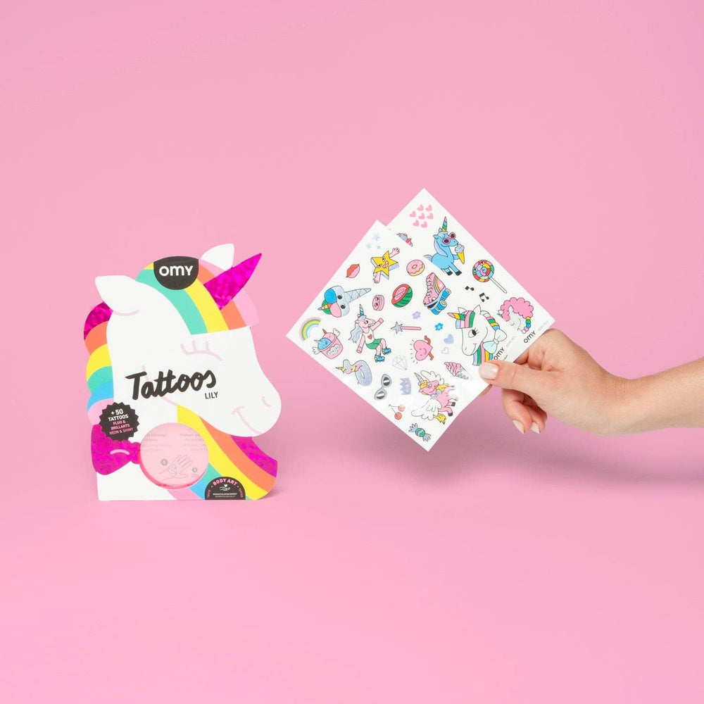 OMY Unicorn Tattoos: hand-held sheet of colorful unicorn stickers shown beside rainbow packaging on pink background.