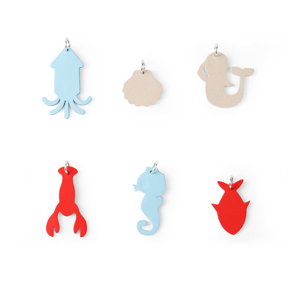 Eyewear charms set six ocean-themed pieces (squid, shell, mermaid, lobster, seahorse, crab) in pastel blues and red by OLIVIO & CO