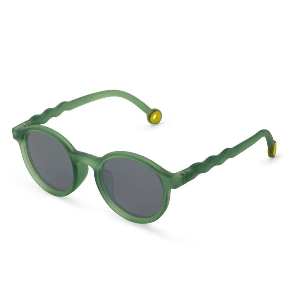 Olivio & Co Oval Sunglasses Kids olive green frame with dark gray lenses resting on a white surface