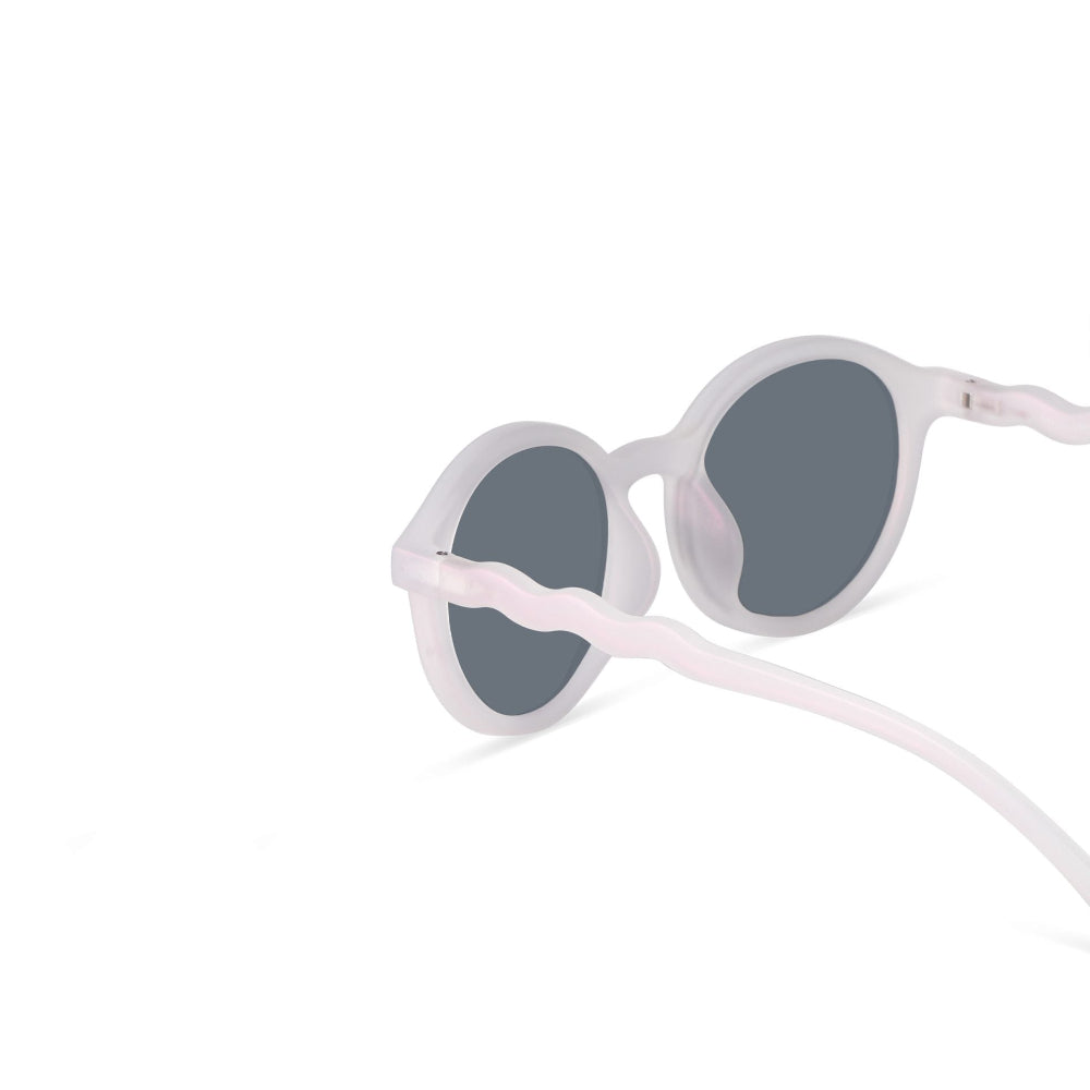 Olivio & Co Oval Sunglasses Adult Classic Olivio Shimmer Pink with gray lenses, curved temples resting on white.