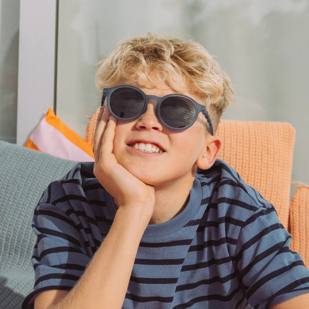 Olivio & Co oval sunglasses junior, Seaside Stripes navy blue, on smiling boy