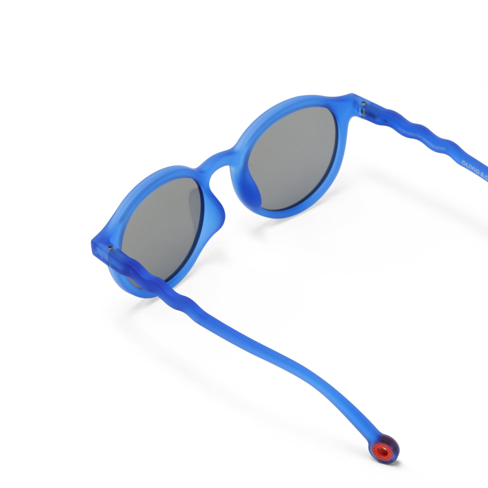 Olivio & Co Oval Sunglasses Kids/Junior Classic Olivio Chagall Blue with gray lenses; blue frames and flexible wavy temples.