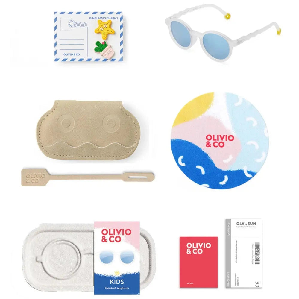 Olivio & Co Oval Kids Sunglasses Jellyfish White shown with beige case and assorted accessories laid out.