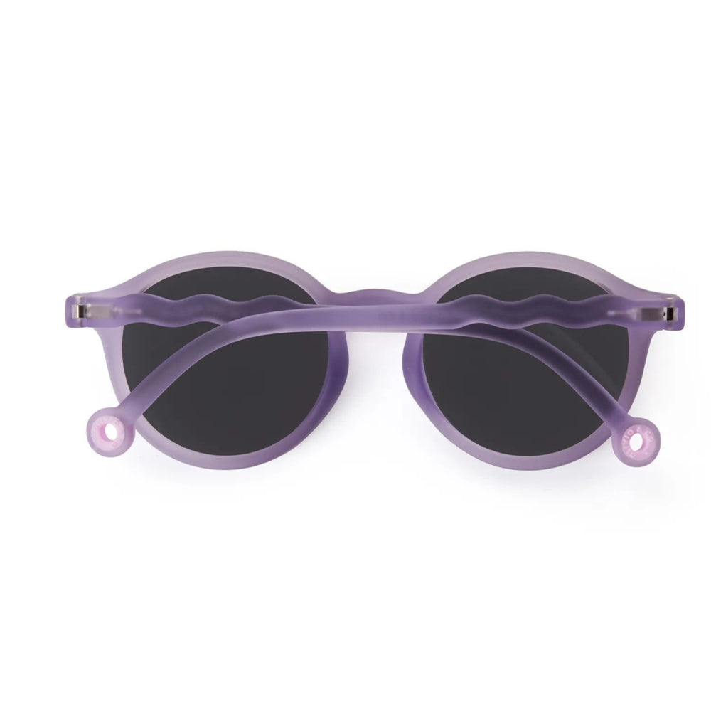 Olivio & Co Oval Sunglasses Kids/Junior Coral Reef Purple Coral with black lenses, purple wavy arms crossed over lenses