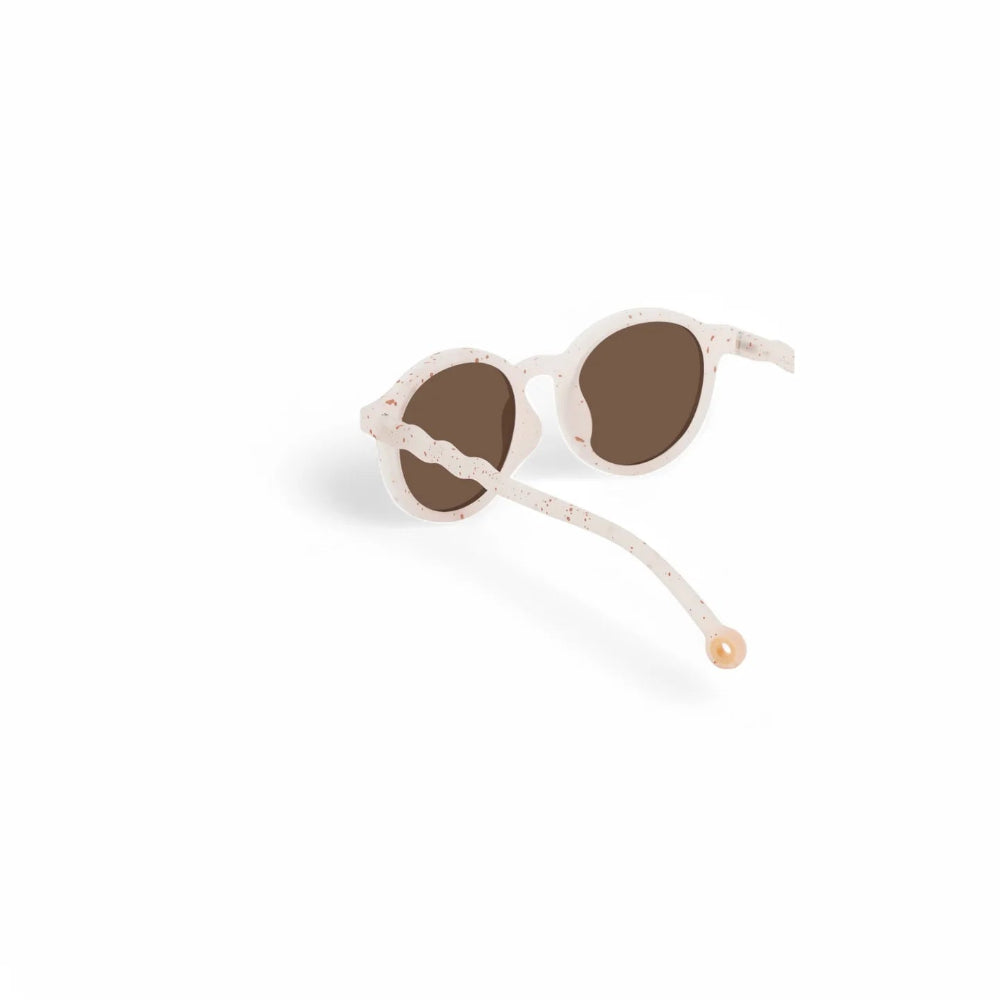 Olivio & Co Oval Sunglasses Kids Gelato Summer Vanilla Brownie on white background with speckled white frame and brown lenses