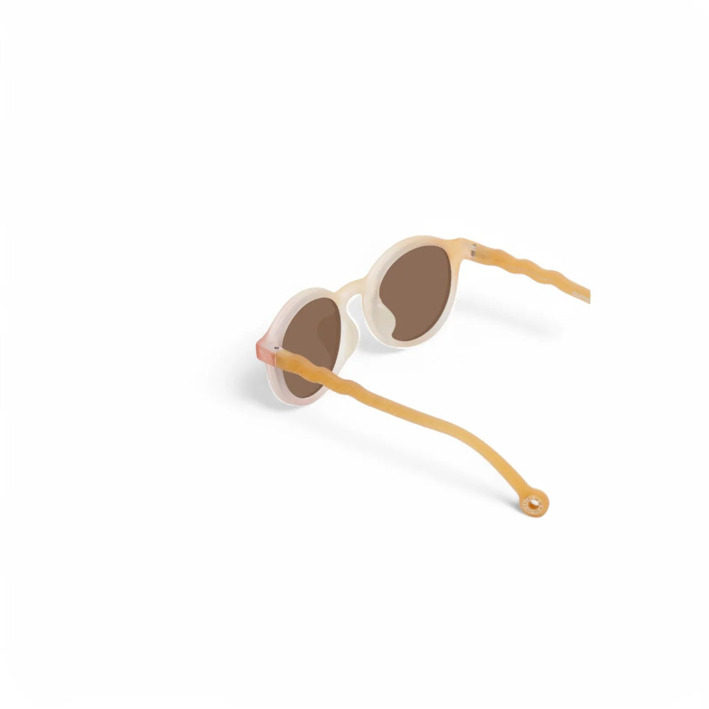 Olivio & Co oval kids sunglasses with white frames and orange waffle temples, brown lenses