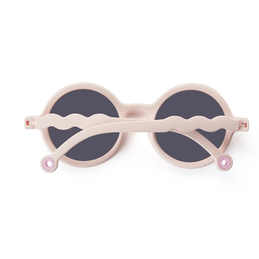 Olivio & Co Round Sunglasses Kids Coral Reef Coral Blush, pink frames with dark lenses, folded.