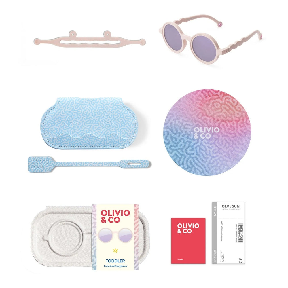 OLIVIO & CO Round Sunglasses Kids Coral Reef Coral Blush with lavender lenses, shown alongside a blue patterned case and cleaning tool set.