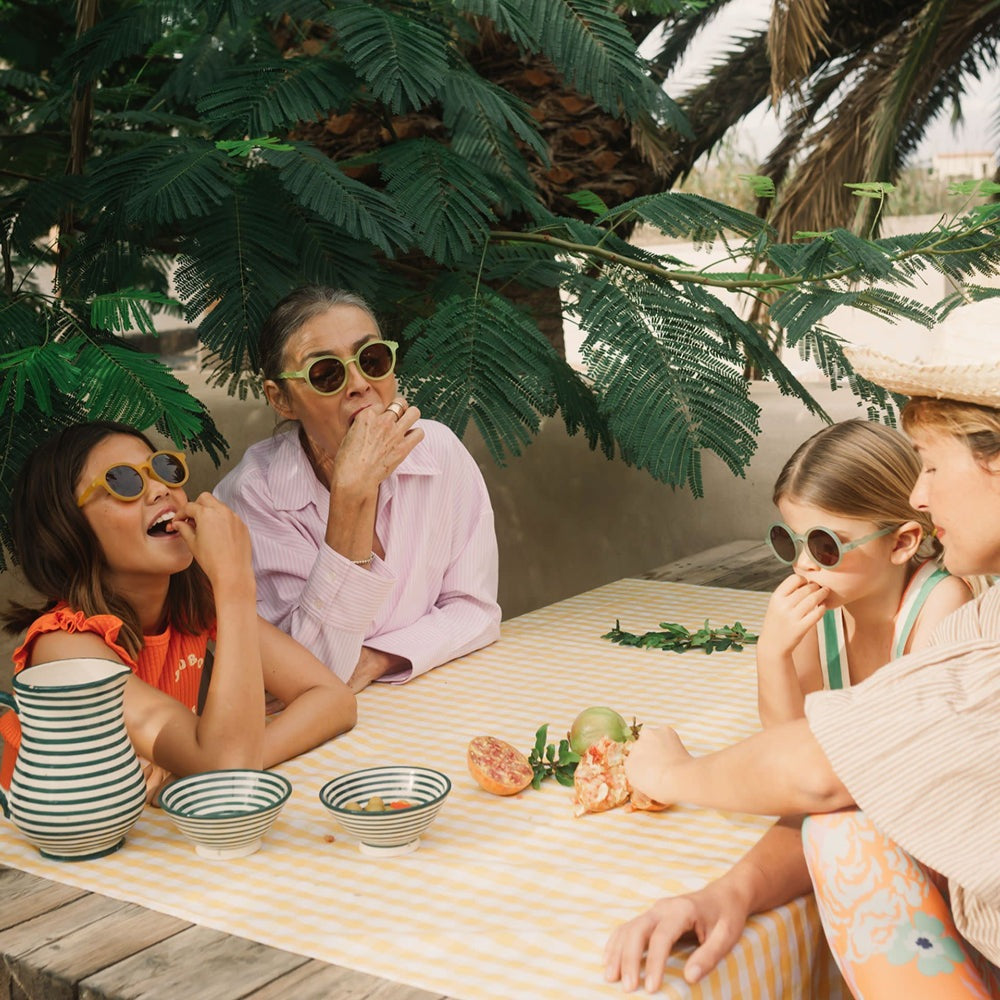 Olivio & Co Round Sunglasses Kids, Citrus Garden, shield young eyes as children snack at a sunny picnic.