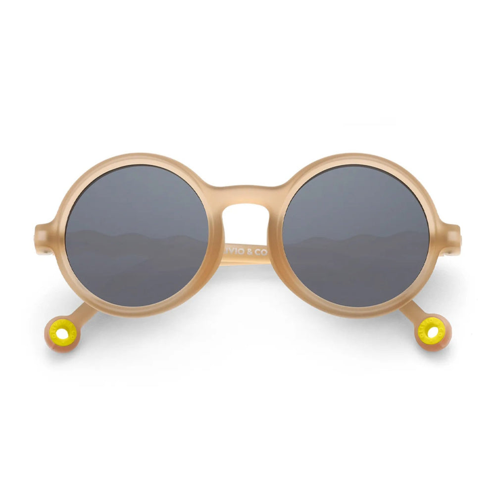 Olivio & Co Round Sunglasses Kids in sand beige with dark gray lenses resting on a white surface