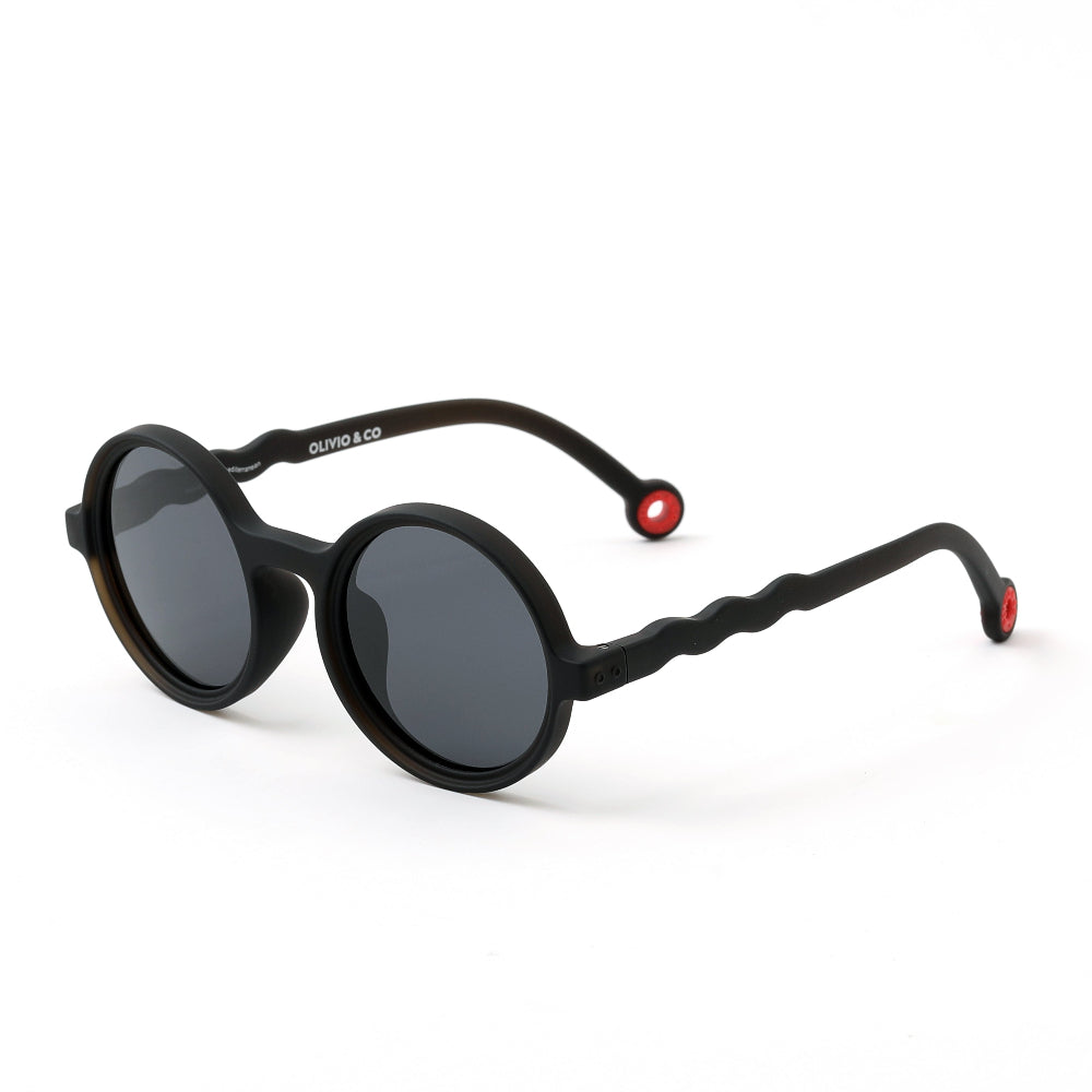 Olivio & Co Round Sunglasses Kids/Junior Classic Olivio Squid Black displayed on white background with dark lenses and red end caps