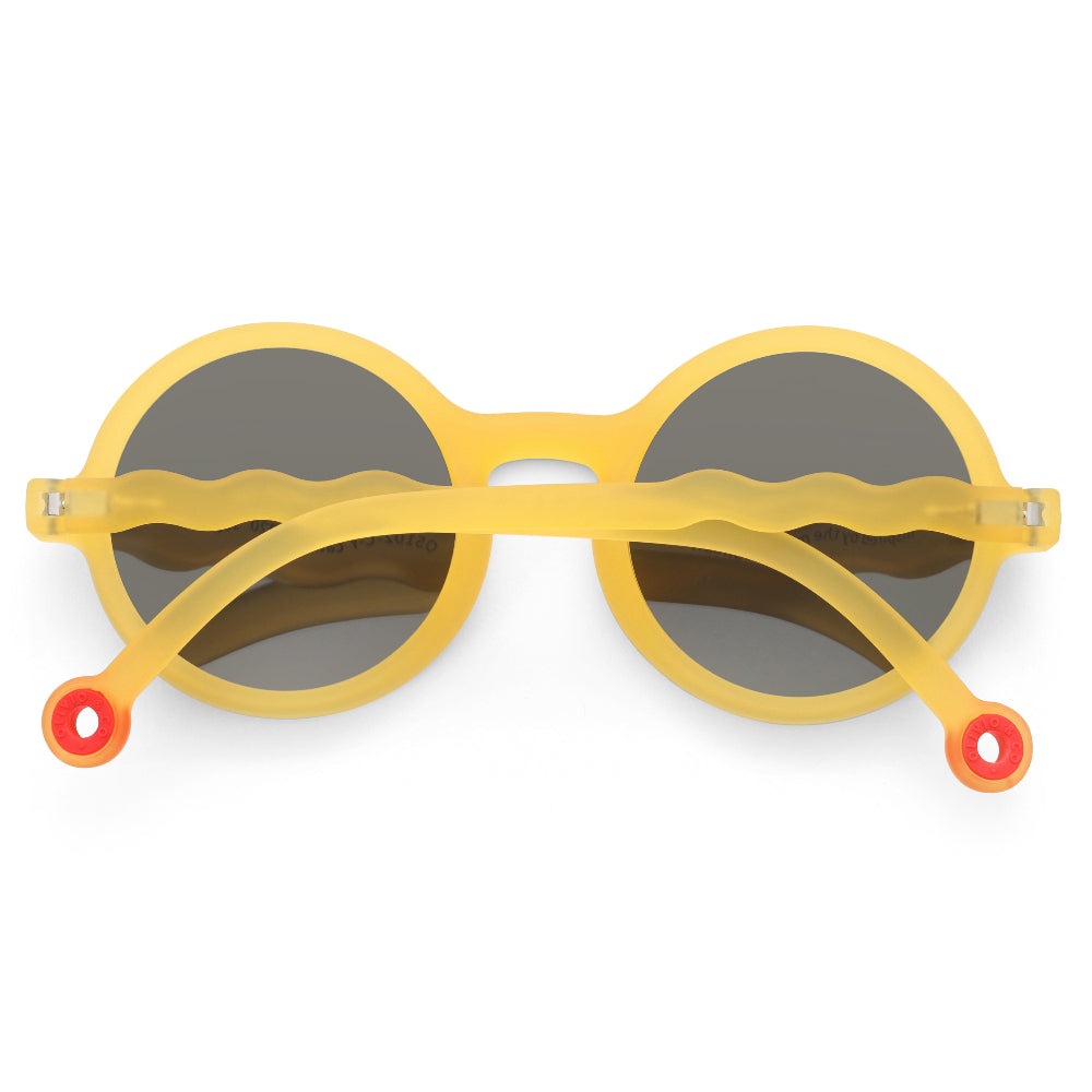Olivio & Co round kids sunglasses in yellow with gray lenses and orange-tipped wavy arms