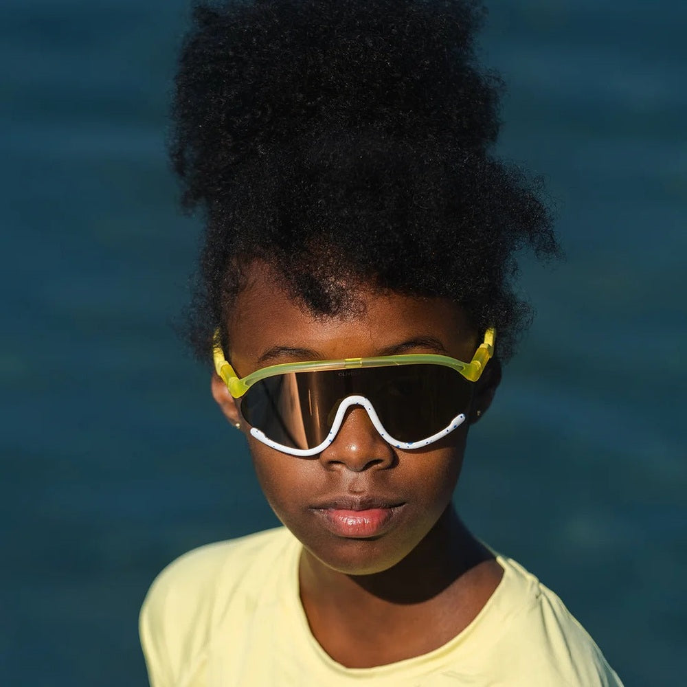 Olivio & Co Sport Sunglasses Junior Daisy Soda worn by a child, lime-yellow full-rim frame with white nose bridge.