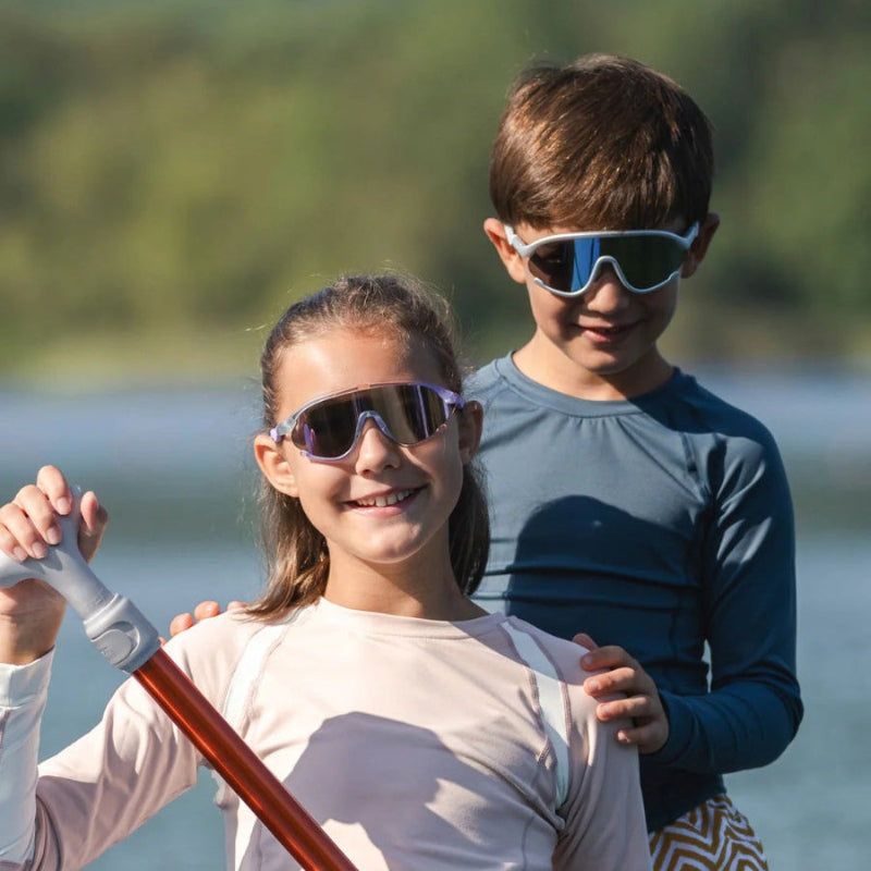Olivio & Co Sport Sunglasses Junior+ Full-Rim Ocean Fantasy; two kids wear mirrored sunglasses outdoors.