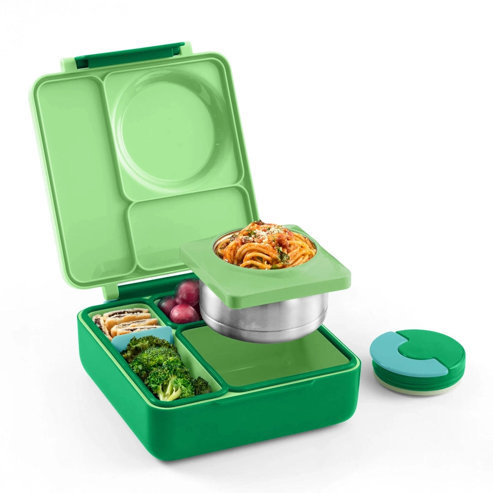 Omiebox Version 2 lunch box in bright green with divided trays; hot pasta insert is placed into the top circular compartment.