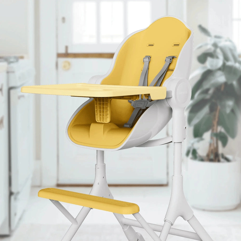 Oribel Cocoon Z high chair lounger with white frame and yellow tray, seat, and footrest.