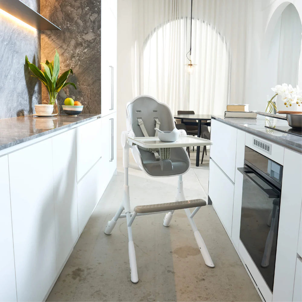 Oribel Cocoon Z high chair lounger in white and grey with tray in a modern white kitchen