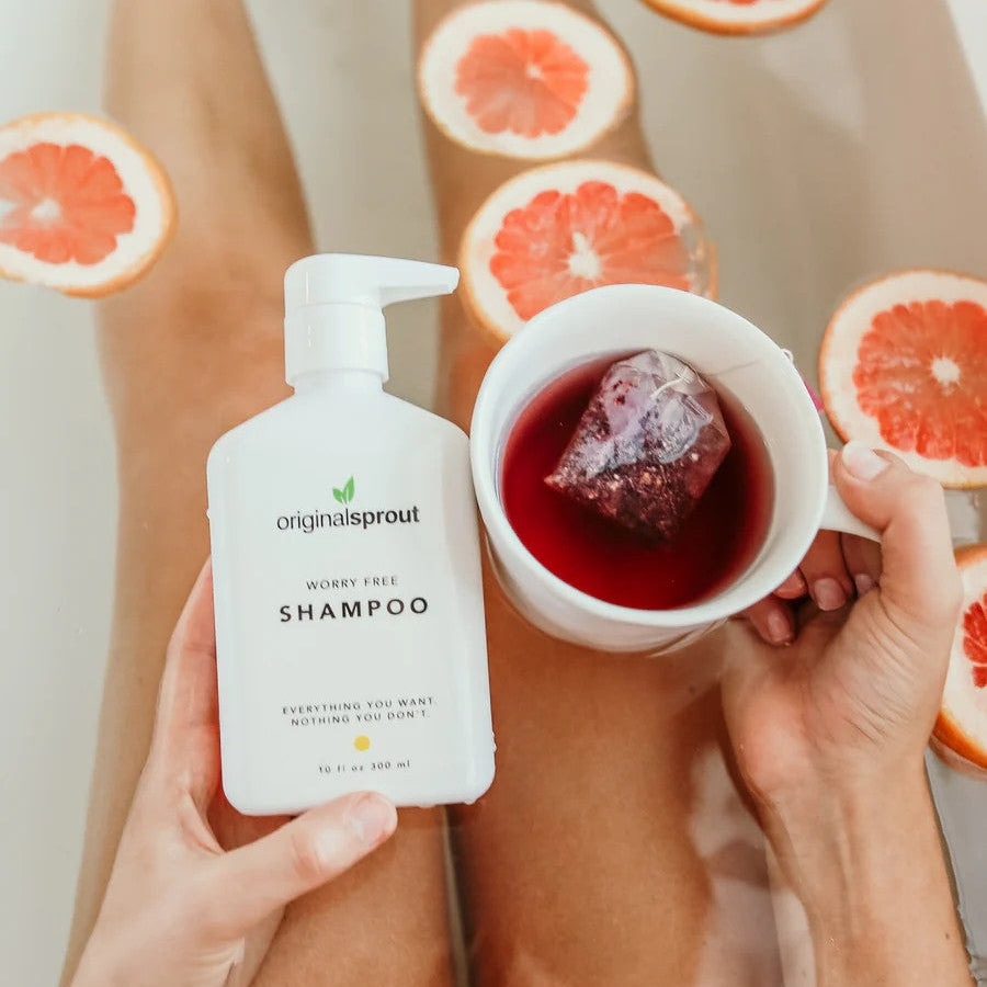 Original Sprout Worry Free Shampoo bottle with pump, white 10 oz, in a grapefruit-filled bath