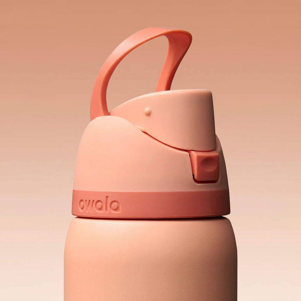 Peach-colored water bottle with a handle on a white background