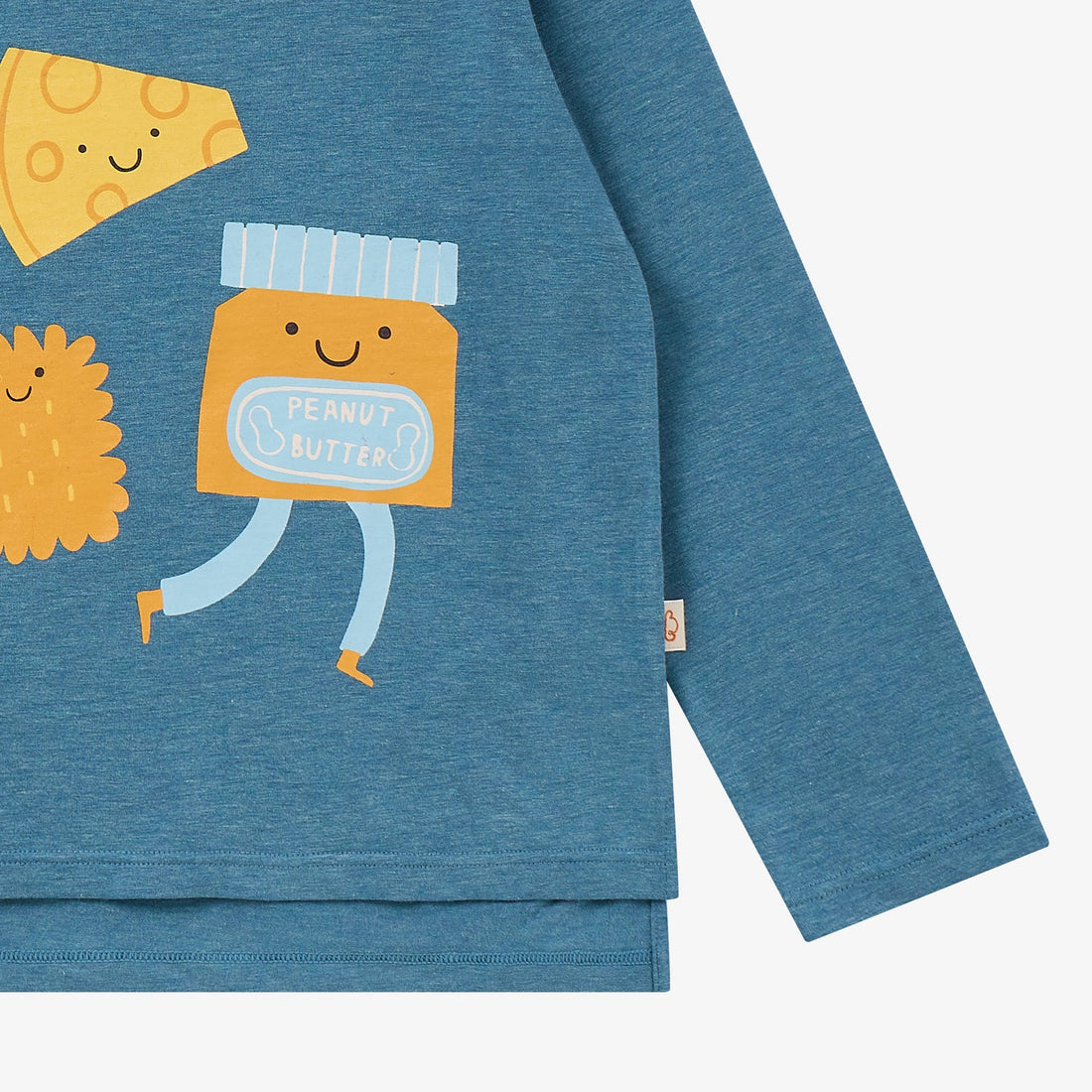 Nest Designs Munchies Long Sleeve Tee in Oceanview blue, detail view of the peanut butter character, sleeve, and hem