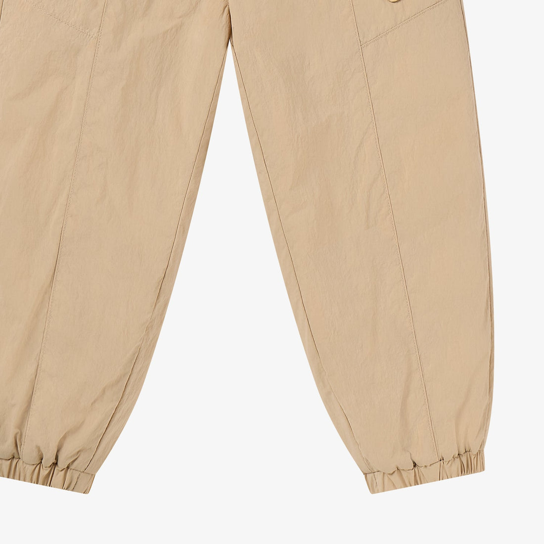 Nest Designs Biscuits & Vine Pants in Toast beige, lower-leg studio detail with long seams and elastic ankle openings