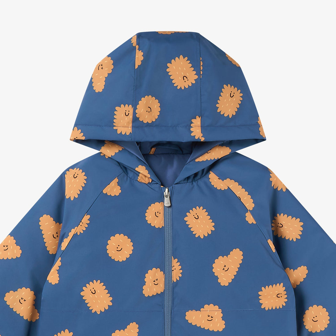 Nest Designs Biscuit Banter Waterproof Down Jacket hood close-up showing the blue shell and scattered orange biscuit characters