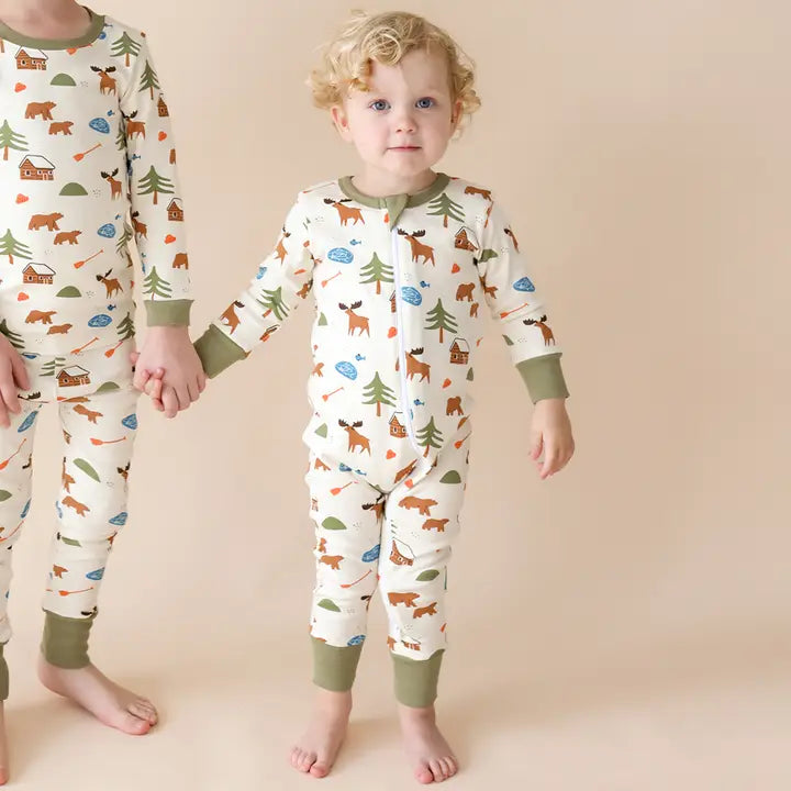 PARADE Parade Organic Signature Print 2-Way Zip Matching Holiday Romper in cream with forest print; toddler holding hands.