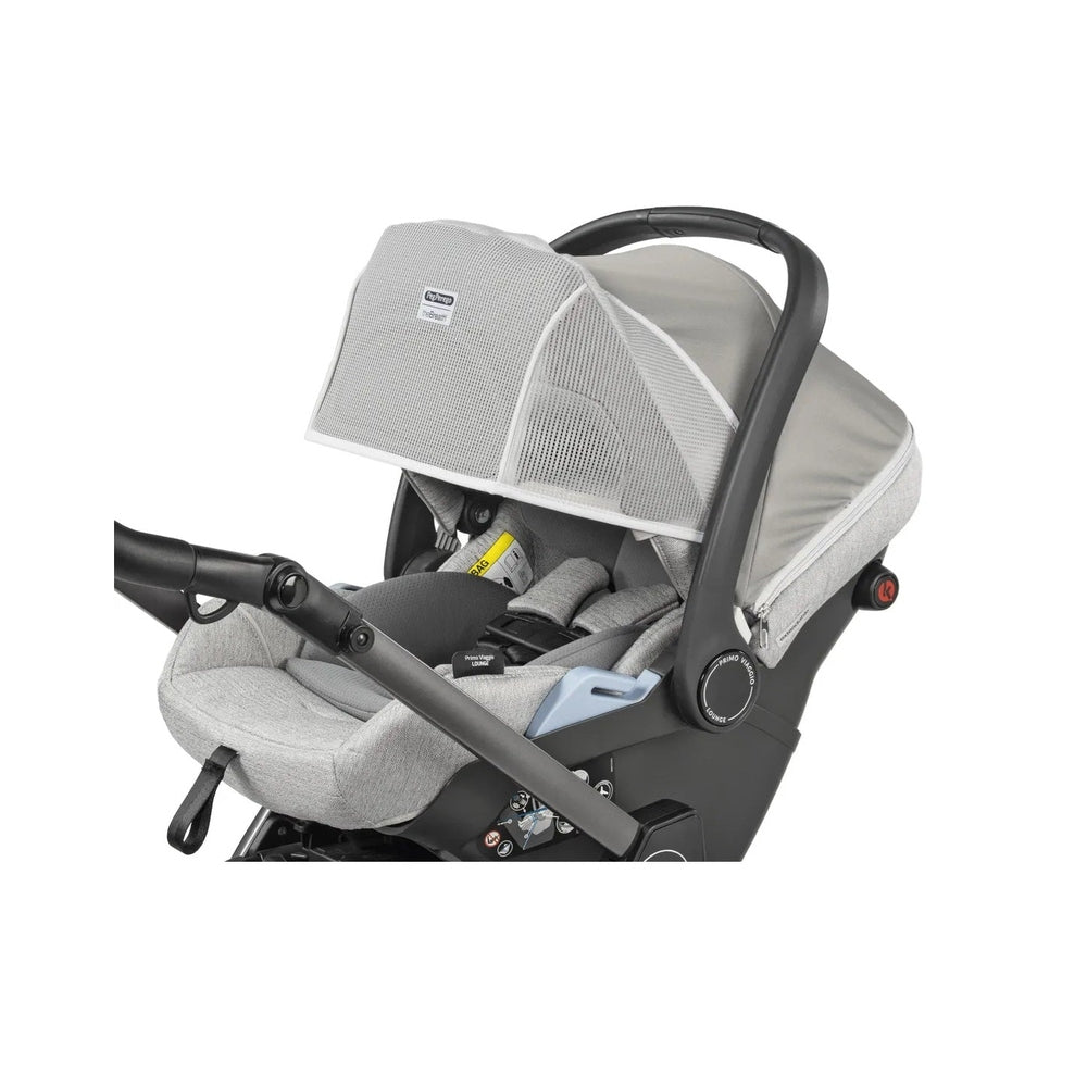 Peg Perego Breath Canopy for Car Seat over a gray infant seat, breathable mesh shade shields from sun.