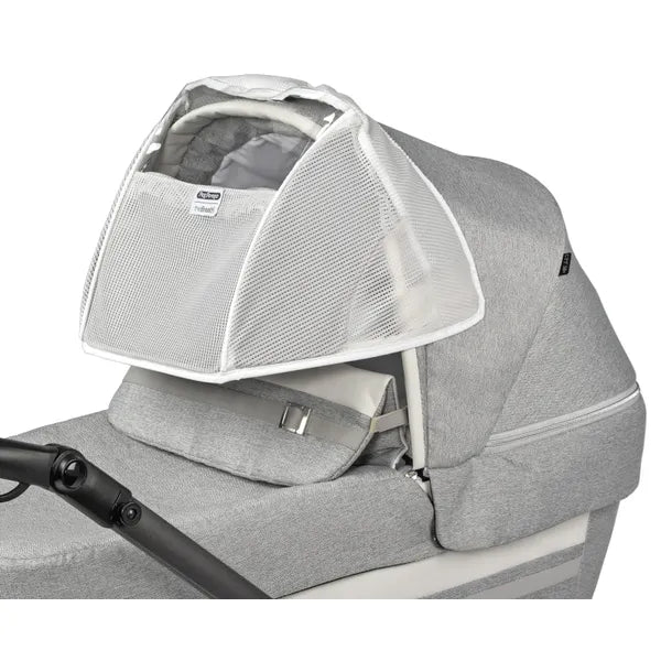 Peg Perego Breath Canopy for Stroller/Bassinet in gray with white mesh panels over the bassinet.
