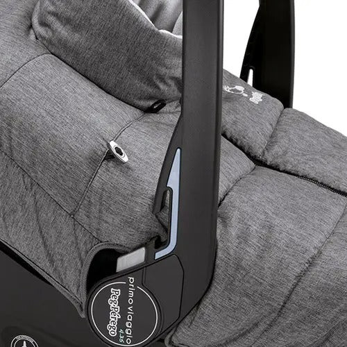 Peg Perego Igloo Car Seat Cover in grey installed on a car seat, showing plush insulated padding and blue trim.