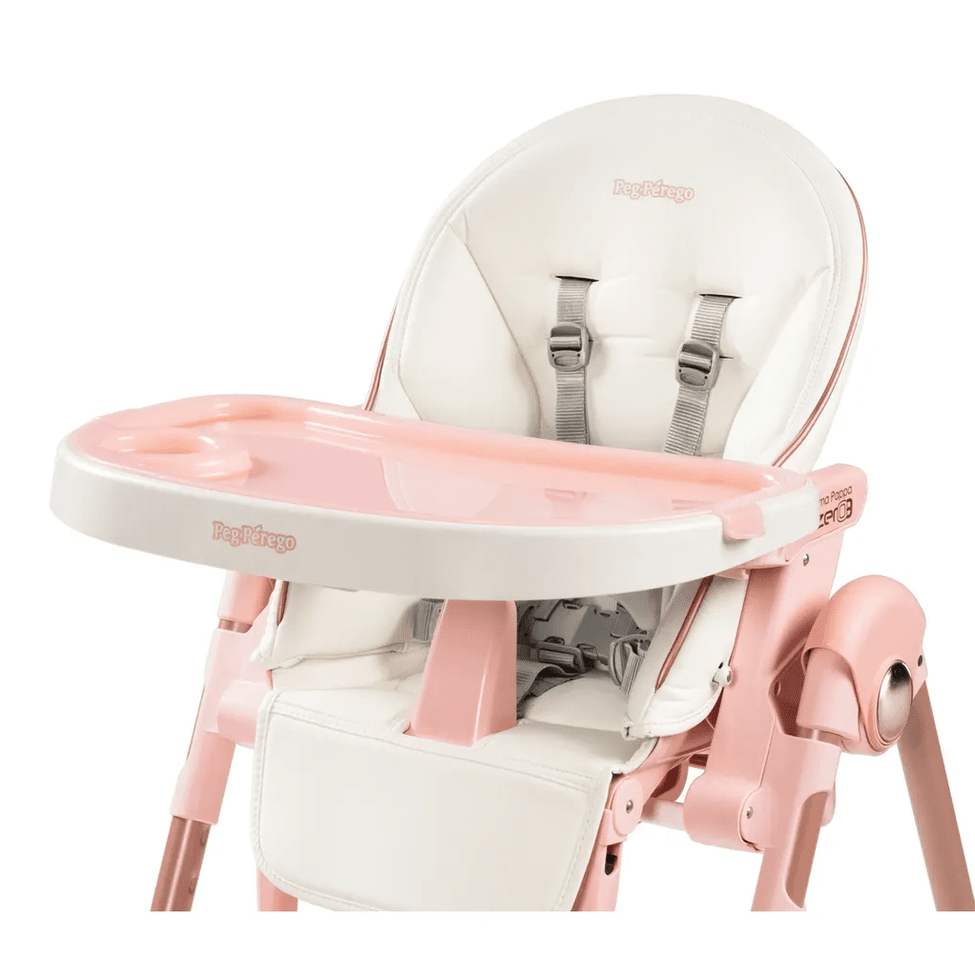Peg Perego Prima Pappa Zero 3 high chair in pastel pink and white with pink tray, safety harness, and adjustable legs.