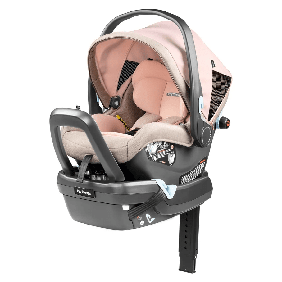 Peg Perego Primo Viaggio Nido Infant Car Seat in blush beige with canopy, mounted on its base with carrying handle deployed.