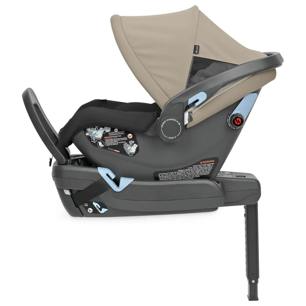 Peg Perego Primo Viaggio Nido infant car seat, dark gray shell with beige canopy and blue accents.