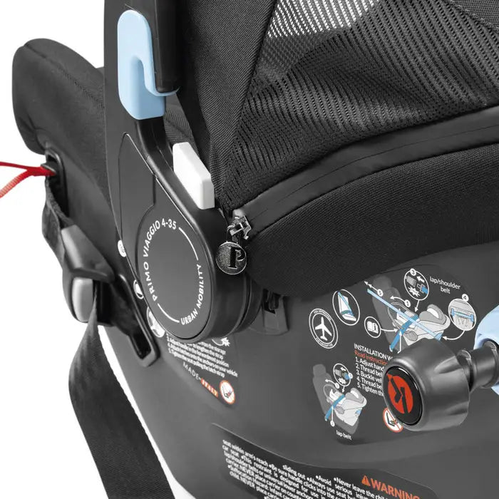 Peg Perego Primo Viaggio Urban Mobility Infant Car Seat in black, showing blue latch release engaged.