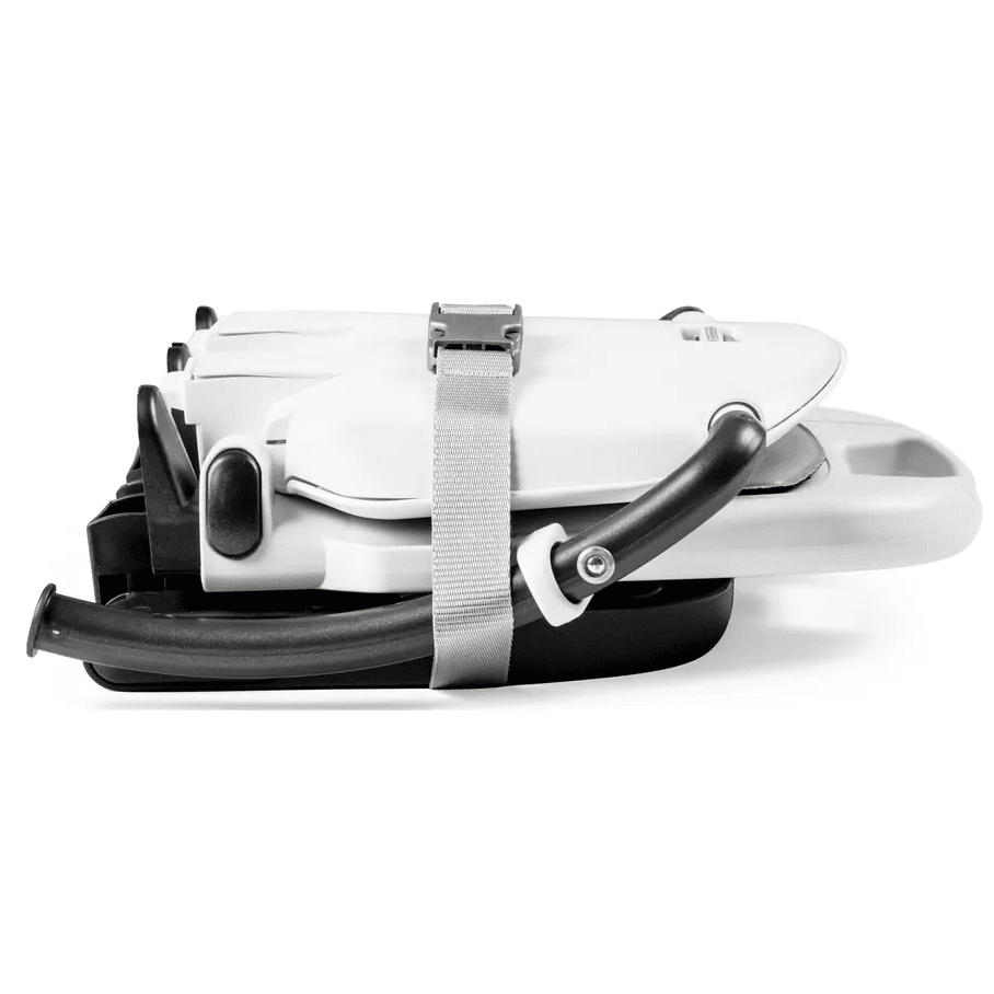 Peg Perego Rialto High Chair folded for compact storage, with a gray strap securing the white chair.