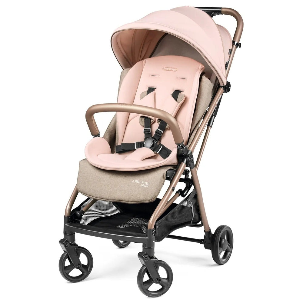 Peg Perego Selfie Plus Stroller in pink with brown frame, sun canopy extended and padded 5-point harness fastened.