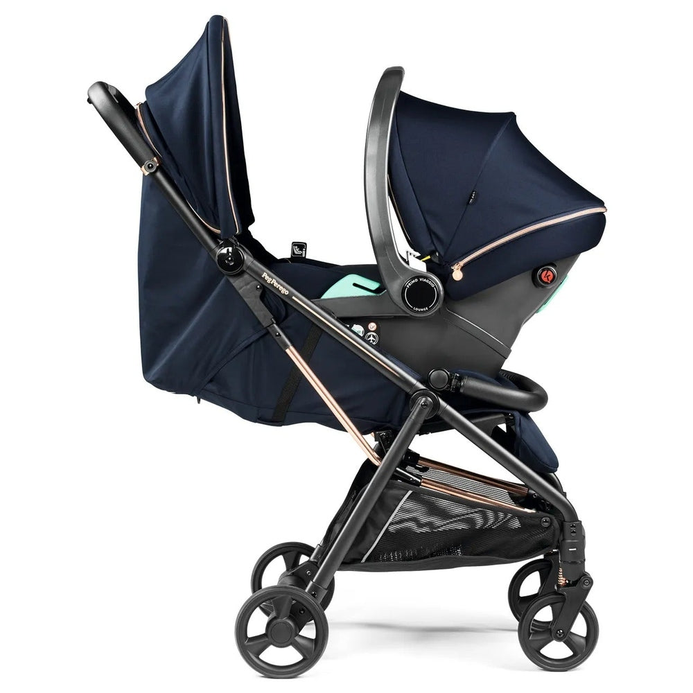 Peg Perego Selfie Plus Stroller in navy with extended canopy and bassinet-style seat on a sleek frame.