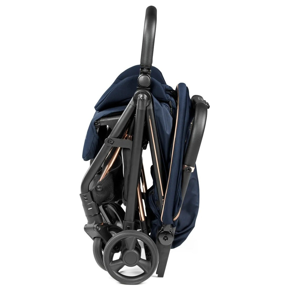 Peg Perego Selfie Plus Stroller in navy, folded compactly with wheels visible for easy storage.
