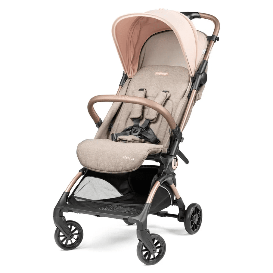 Peg Perego VOLO Travel Stroller in beige fabric with tan frame; canopy up and 5-point harness visible.