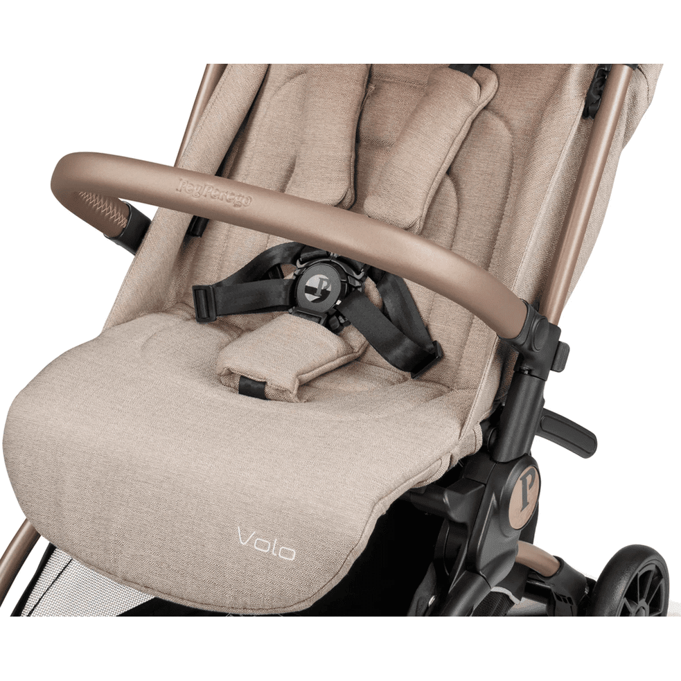 Peg Perego VOLO Travel Stroller in beige with padded seat, front bumper bar, and 5-point harness.