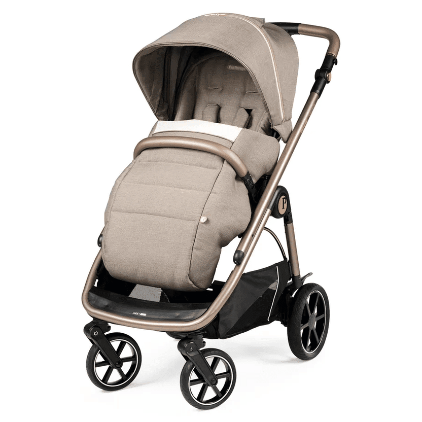 Peg Perego Veloce Stroller in beige with foot muff and extended canopy, showcasing its sturdy frame.