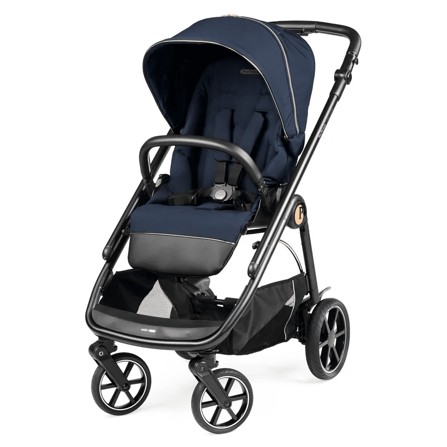 Peg Perego Veloce Stroller in navy with foot muff, being pushed with canopy extended.
