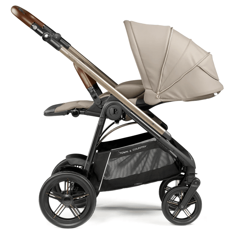 Peg Perego Velcoe TC Stroller with beige canopy and bronze frame, highlighting 4 wheels and roomy storage basket