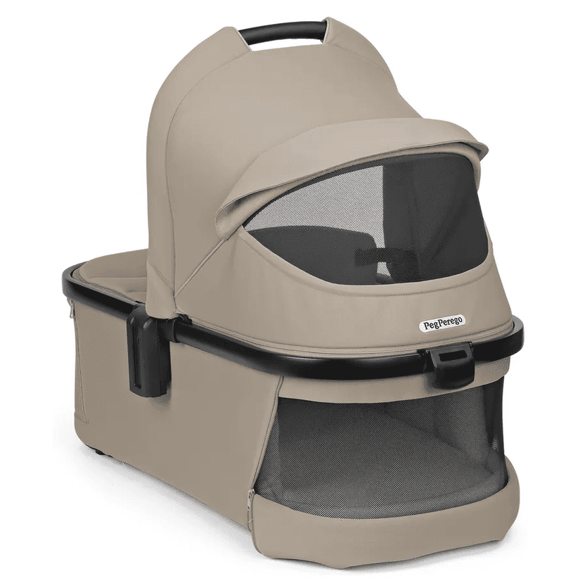 Peg Perego YPSI Bassinet with Stand By Me in beige, shown with mesh viewing window and protective canopy.