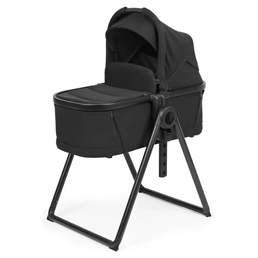 Peg Perego YPSI Bassinet with Stand By Me in black, bassinet securely mounted on an adjustable metal stand.