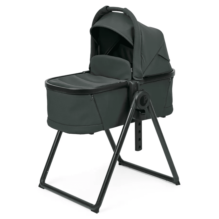 Peg Perego YPSI Bassinet with Stand By Me in dark green, bassinet securely perched on sturdy adjustable metal stand.