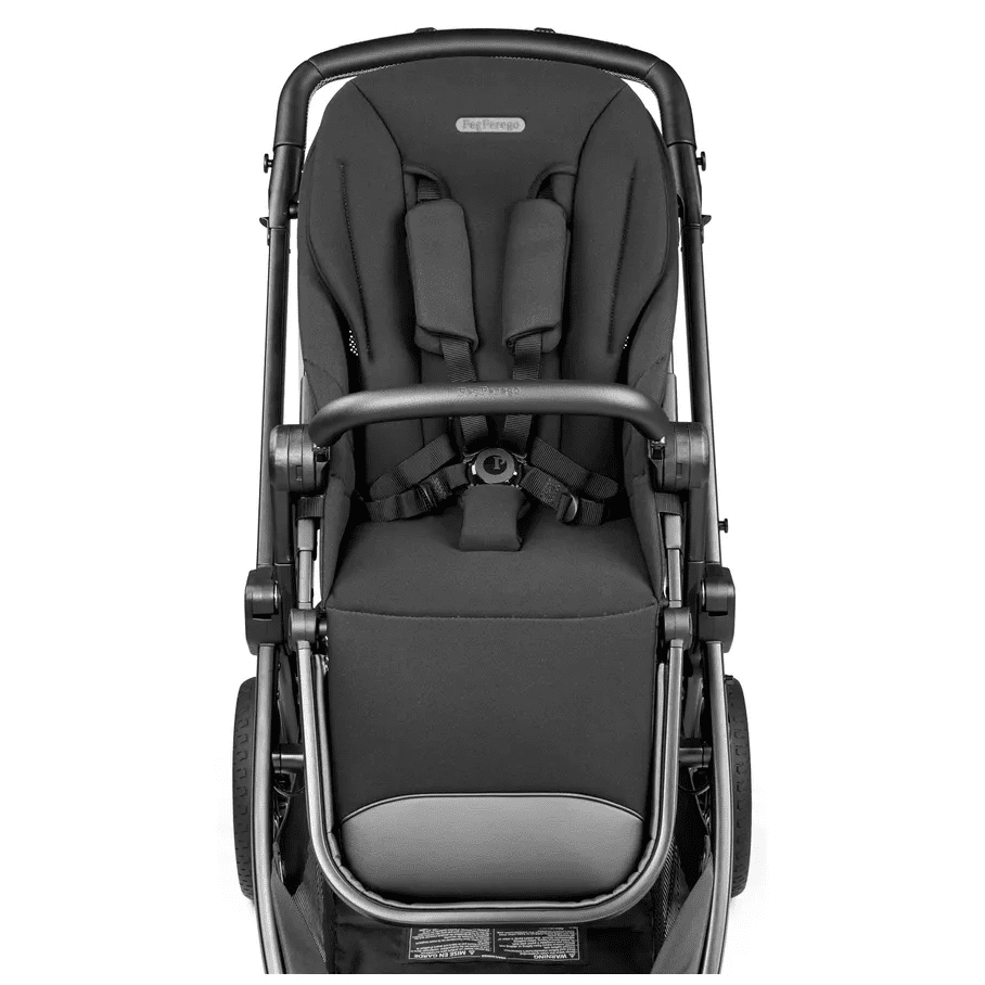 Peg Perego YPSI Companion Seat in black, showcasing padded five-point harness buckled on a compact stroller frame.