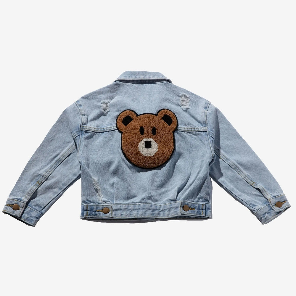 Petite Hailey Bear Patched Denim Jacket in light blue; back shows a large bear patch and distressed rips.