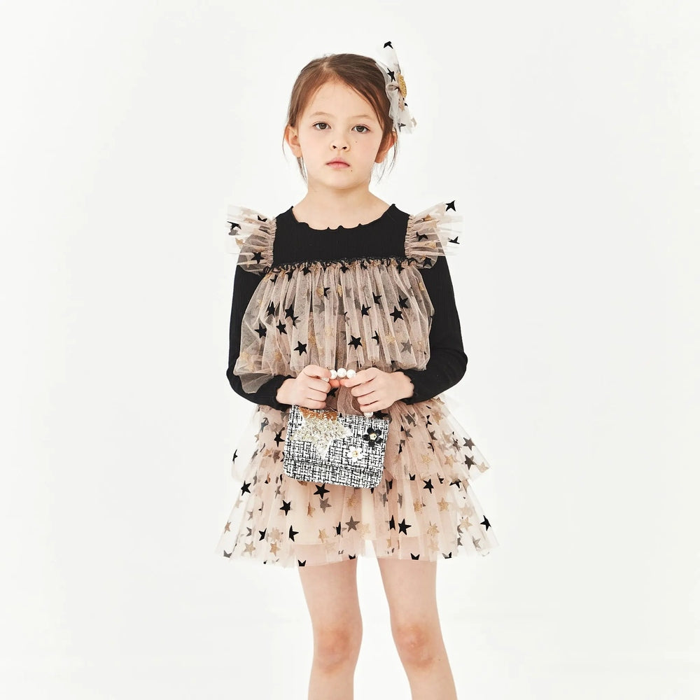 Petite Hailey Layered LS Tutu Black Star dress: beige star-tulle over black top, girl holds a glittery mini bag.