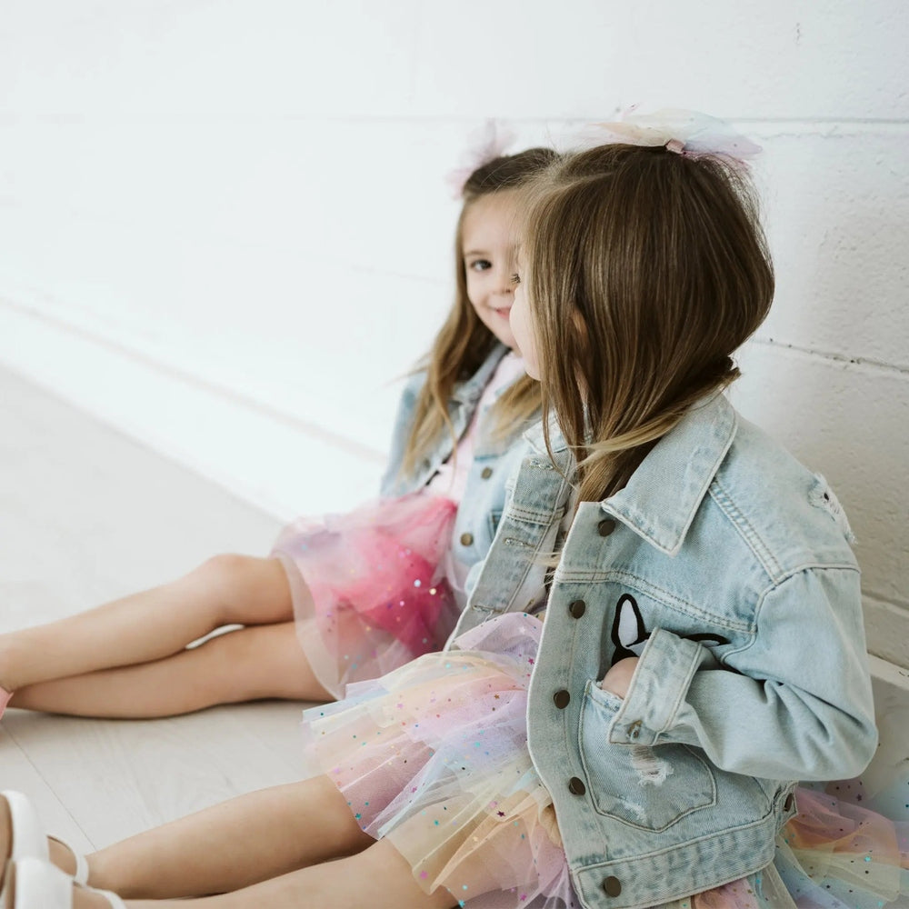 Petite Hailey Patched Denim Jacket Yellow Smile worn by two girls in pastel tutu outfits.